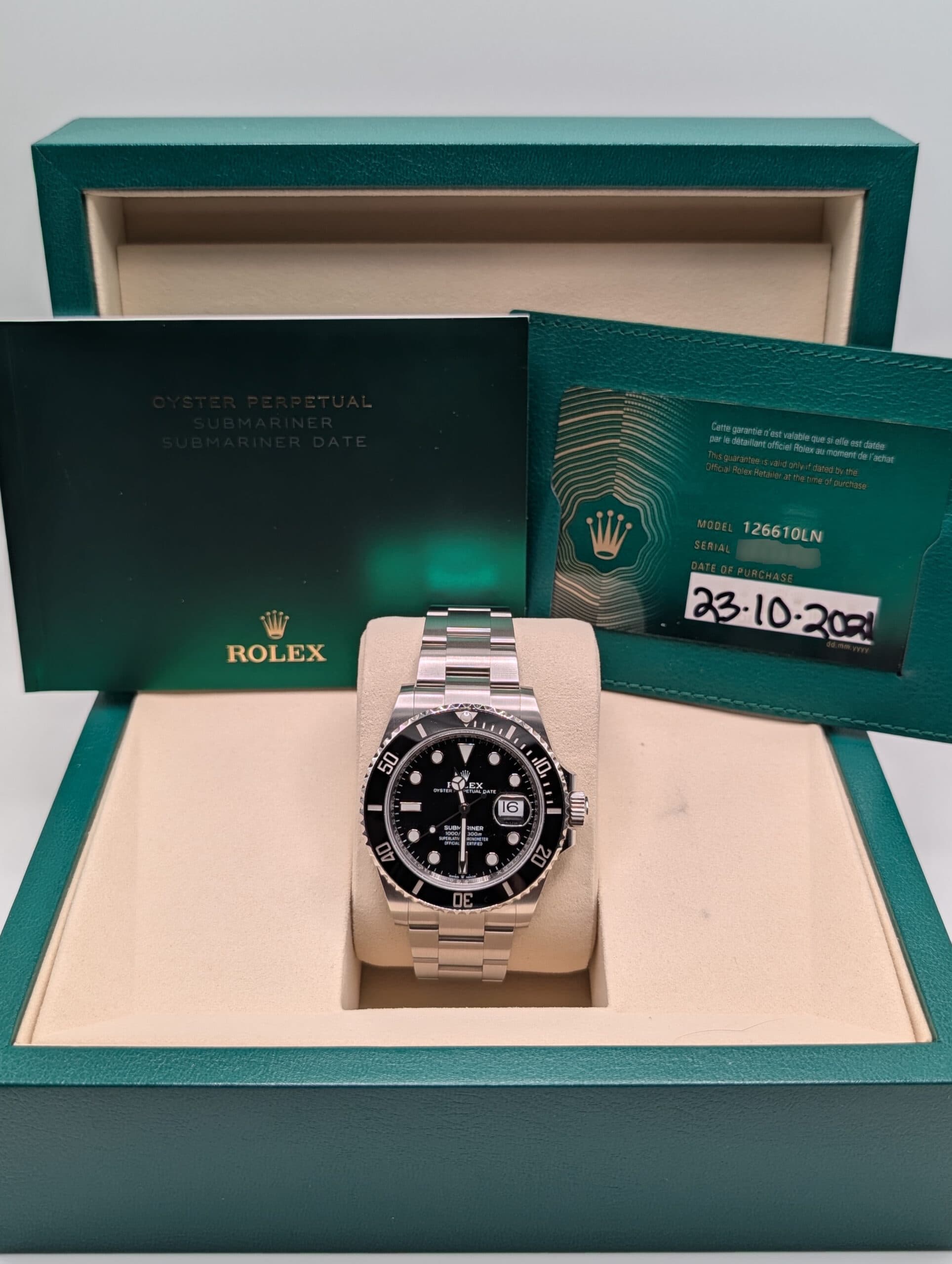 Rolex Submariner Date with warranty information.